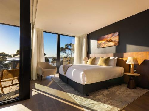 a bedroom with a bed and a large window at Mercure Kangaroo Island Lodge in American River