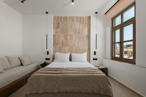 a bedroom with a bed and a couch at Karavel Suites - Old Town in Rhodes Town