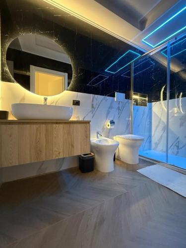 a bathroom with two toilets and a sink at La Dea Fuoco in Torre del Greco