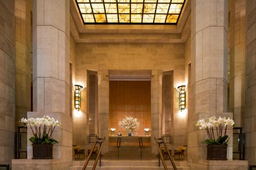 a lobby of a building with a table and flowers at Four Seasons Hotel New York in New York