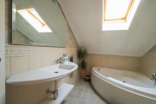 a bathroom with a sink and a tub and a mirror at Mazziu's villa in Cans
