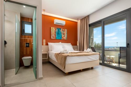 a bedroom with a bed with an orange wall at Madison Boutique, Faliraki in Faliraki
