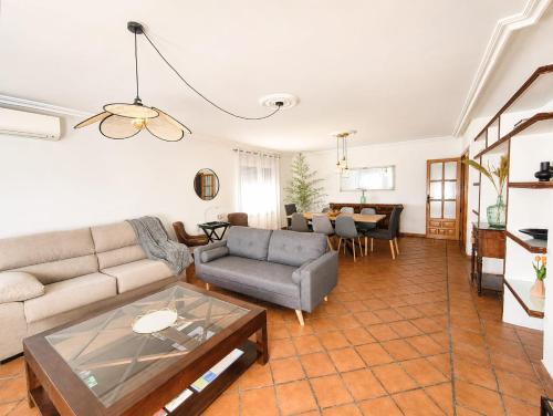 a living room with a couch and a table at El encinar de las nieves - Piscina privada, cerca de Toledo y Puy du Fou in Toledo