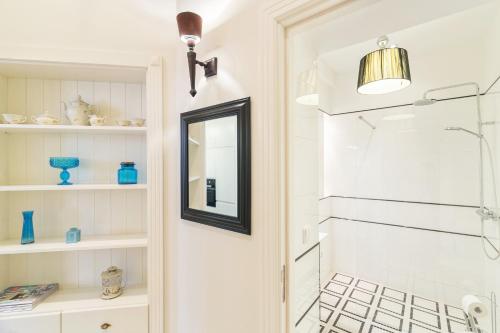 a bathroom with a shower and a mirror at Sopot Monte Cassino Wiktoria Apt in Sopot