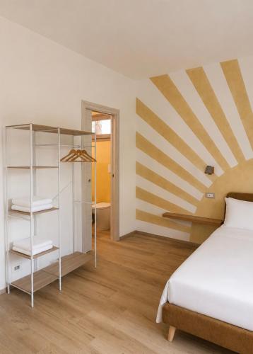 a bedroom with a bed and a striped wall at Minnanni in San Pantaleo