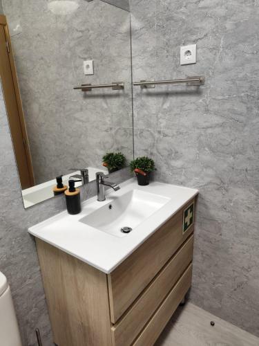a bathroom with a sink and a mirror at Villa Jeronimo`s in Geres