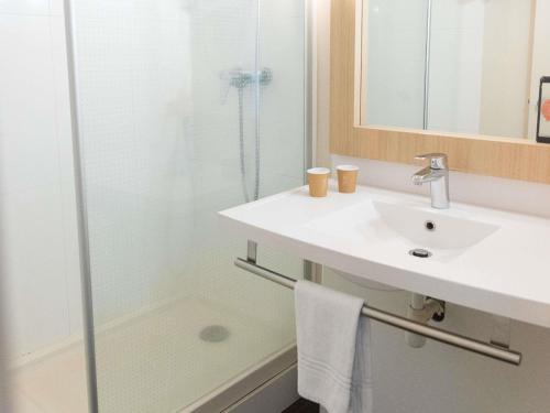 a bathroom with a sink and a shower at ibis Styles Chinon in Chinon