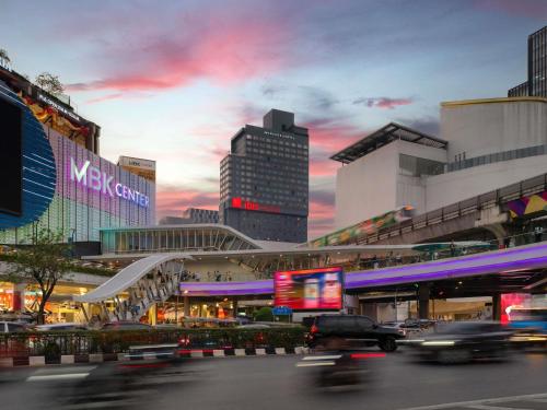 a city with buildings and cars on a street at ibis Bangkok Siam in Bangkok