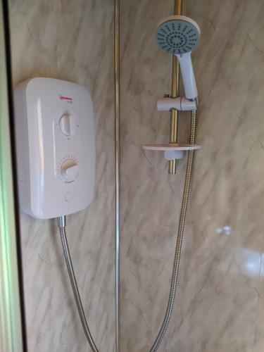 a shower with a hair dryer in a bathroom at Hal`s at Killynick in Killyhevlin