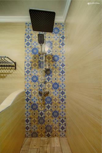 a room with a tile wall with a light at blue moon in Chefchaouen