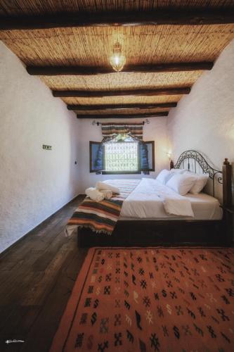 a bedroom with a large bed and a window at blue moon in Chefchaouen