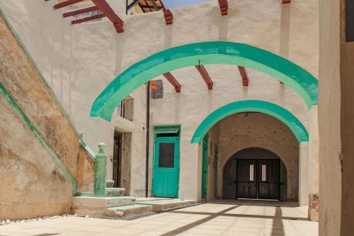 an archway in a building with a green door at Villa Mineli in Campeche