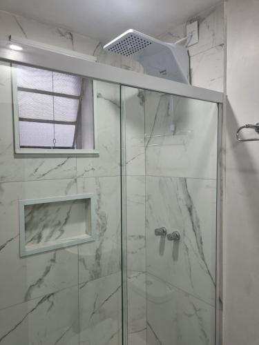 a bathroom with a shower with a glass door at Flora e Fauna in Porto Alegre