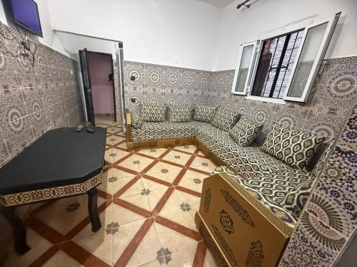 a living room with a couch and a table at Katalan in Martil
