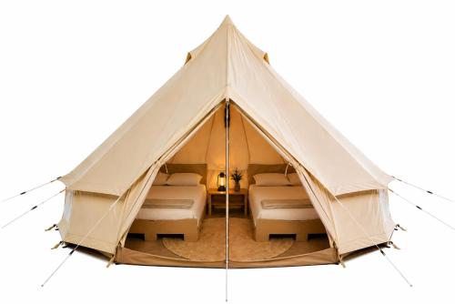 a canvas tent with two beds in it at NIBIRU OFFICIAL ACCOMMODATION LUNR Camp in Costinesti