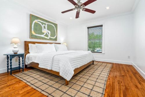 a bedroom with a bed and a ceiling fan at Saturdays In The South in Auburn