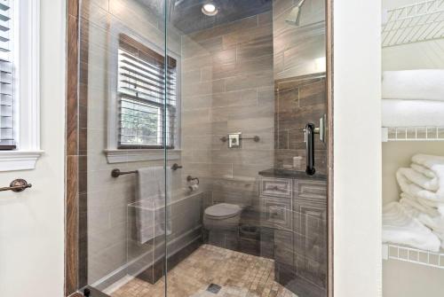 a bathroom with a shower with a toilet and a glass door at Saturdays In The South in Auburn