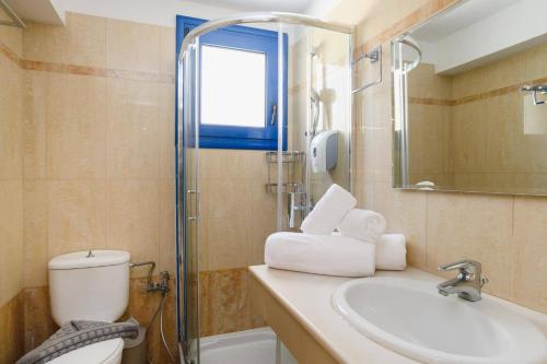 a bathroom with a toilet and a sink and a shower at Villa Kalymnos by Villa Plus in Kolymbia