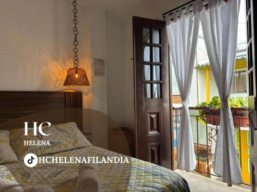 a bedroom with a bed and a door to a balcony at HC Helena in Filandia