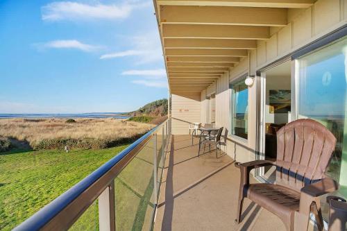 a balcony with chairs and a view of the ocean at Hi-Tide Resort Queen Bed Unit 12 in Moclips