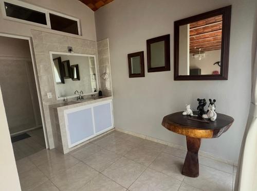 a bathroom with a wooden table and a sink at Hotel El Texcalame in Lo de Marcos