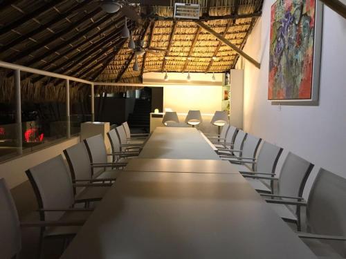 a long long table and chairs in a room at Luxury Villa by the Lake in Tequesquitengo