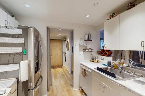 a kitchen with a sink and a refrigerator at City Lights at Newmark - World Cup Availability in Seattle