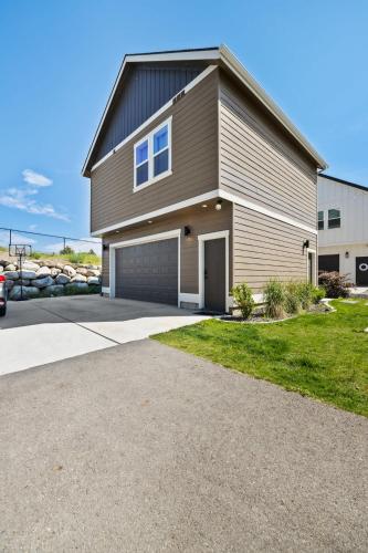 a large house with a garage and a driveway at Modern Loft Private Golf Course Retreat in Post Falls