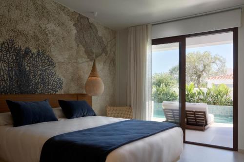 a bedroom with a bed and a sliding glass door at Ananda Mojácar - Only Adults in Mojácar