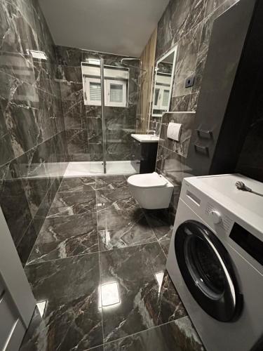 a bathroom with a shower and a toilet and a sink at Villa Maria II in Vodice