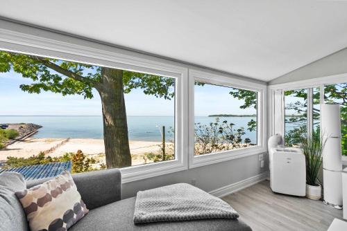 a living room with a view of the ocean at Crystal Beach Waterfront Cottage - Sunset Views in Fort Erie