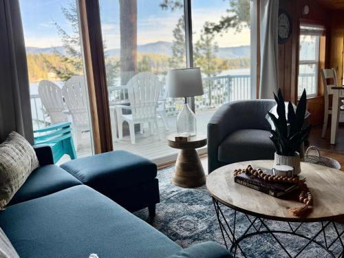 a living room with a couch and a table at Lakefront Cabin Dock Kayaks & Fire Pit in Hayden