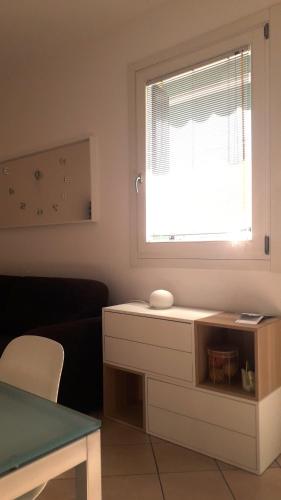 a living room with a window and a white table at Casa al parco in Romano D'Ezzelino