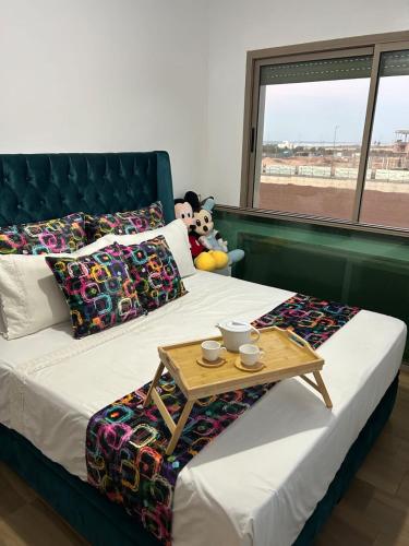 a bedroom with a bed with a table on it at Diamond Blue in Sidi Rahal
