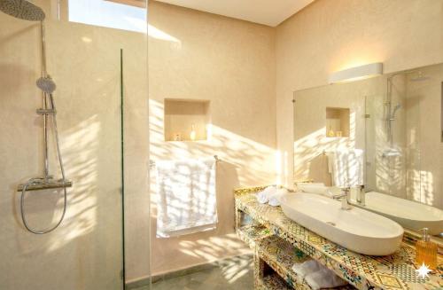 a bathroom with a sink and a shower at Bab Sma in Oumnas