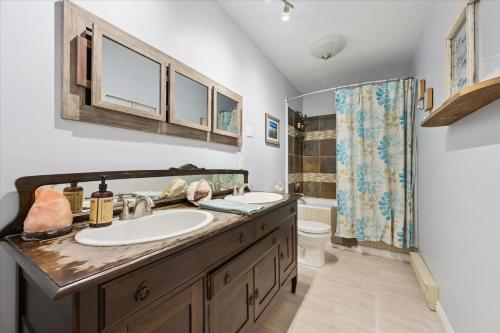 a bathroom with a sink and a toilet at Larkwhistle Sauna Chickens Near BEACHES in Wiarton