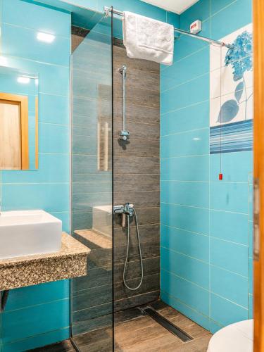 a bathroom with blue walls and a glass shower at Boulevard Luxury Apartments City Center Ohrid in Ohrid