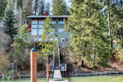 a house on the shore of a lake with a staircase at Lake House Private Dock & Decks 4BR in Hayden