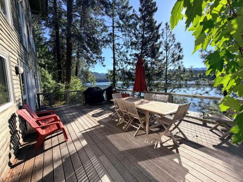 a wooden deck with a table and chairs on it at Lake House Private Dock & Decks 4BR in Hayden