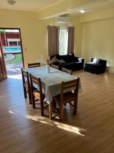 a living room with a table and chairs and a couch at Mango Home - Casa privada con pileta in Puerto Iguazú