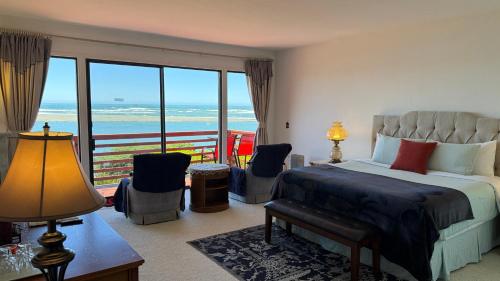 a bedroom with a bed and a view of the ocean at Arky's B&B in Smith River