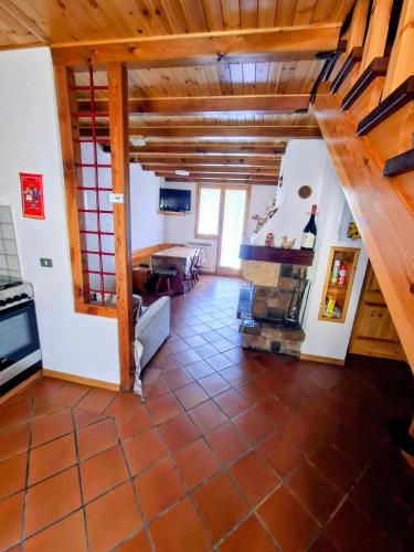 a living room with a staircase and a table at Casa vacanze Pievepelago in Pievepelago