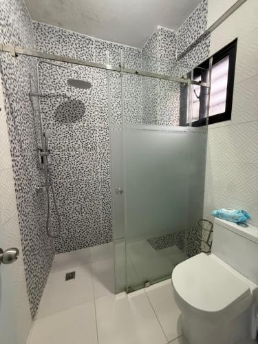 a bathroom with a toilet and a glass shower at La casita de Polo in Polo