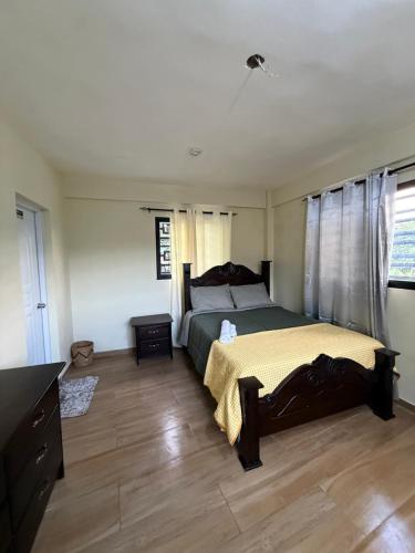 a bedroom with a bed and a wooden floor at La casita de Polo in Polo