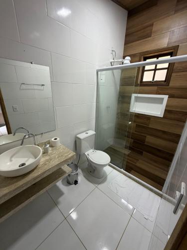 a bathroom with a toilet and a sink and a shower at Pousada céu azul Paraty in Paraty