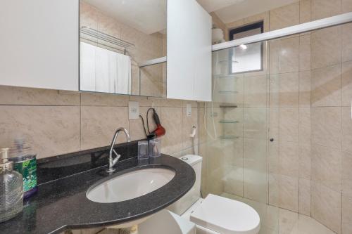 a bathroom with a sink and a toilet at Atlântico Flat Beira Mar in Natal