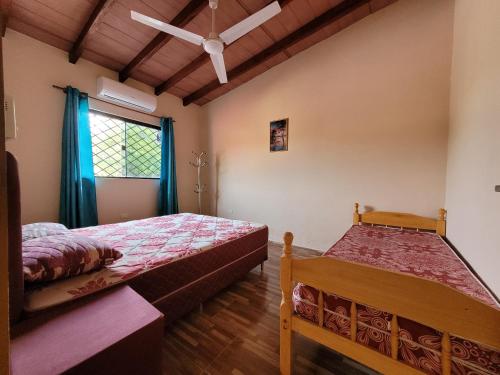 a bedroom with two beds and a window at Don Roque in Piribebuy