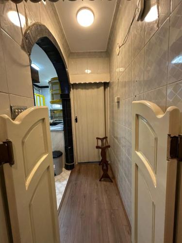 a hallway with an archway and a door in a room at 2 Bedrooms Spacious flat 7 mins to Airport in Cairo