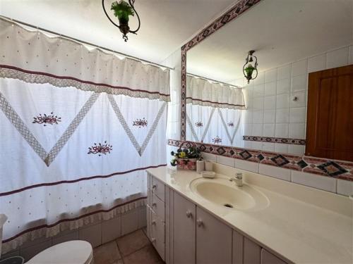 a bathroom with a sink and a mirror at El Estero Lago Rapel in El Estero