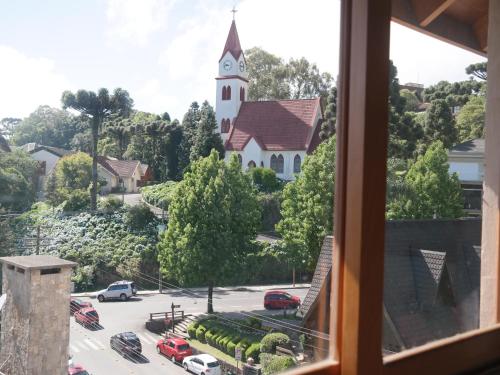 a view of a church from a window at Ótima Localização e Vista da Cidade in Gramado